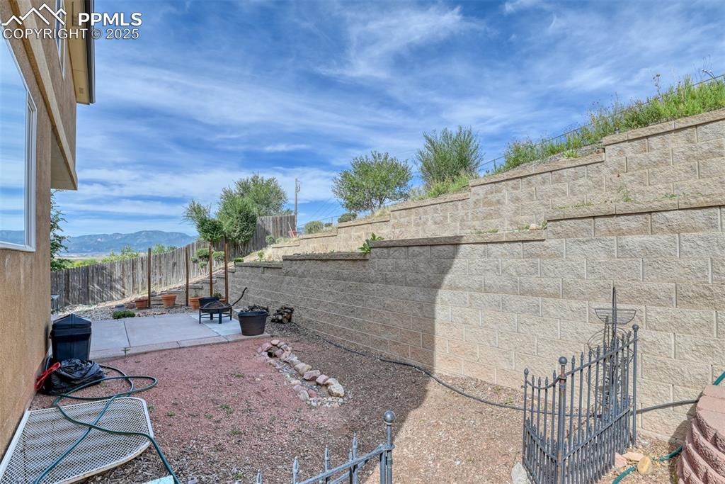 Image 44 of 49: Fenced backyard featuring a patio