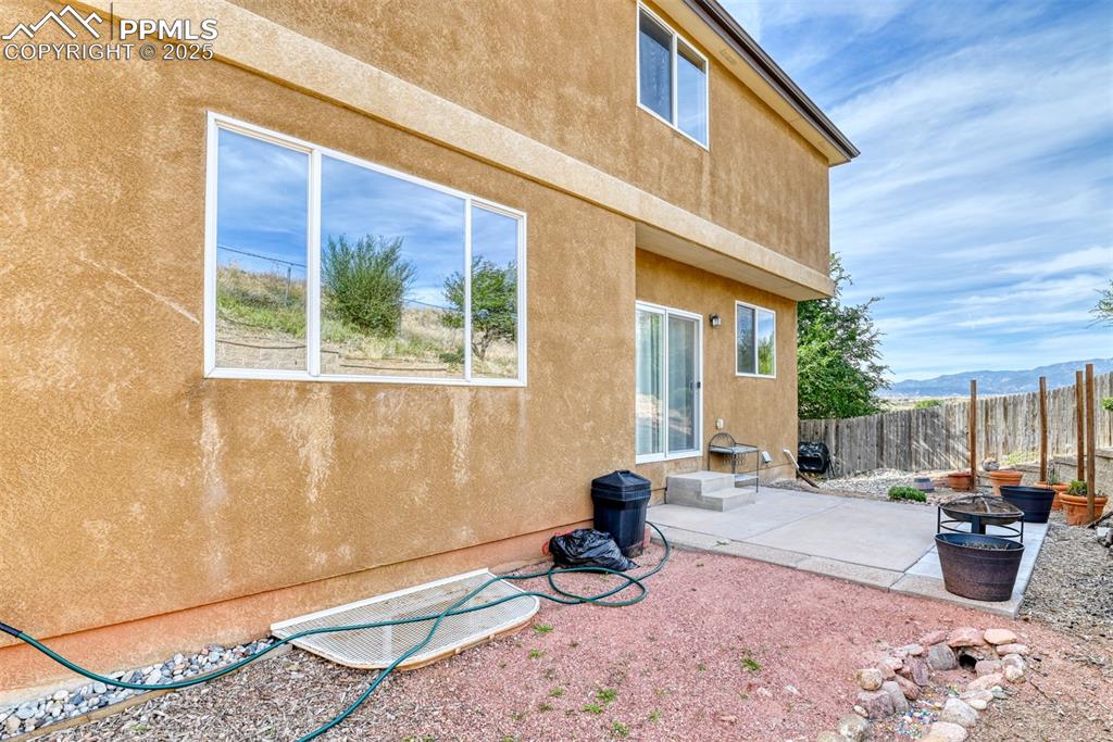 Image 45 of 49: Rear view of property featuring stucco siding, a patio, and a mountain view