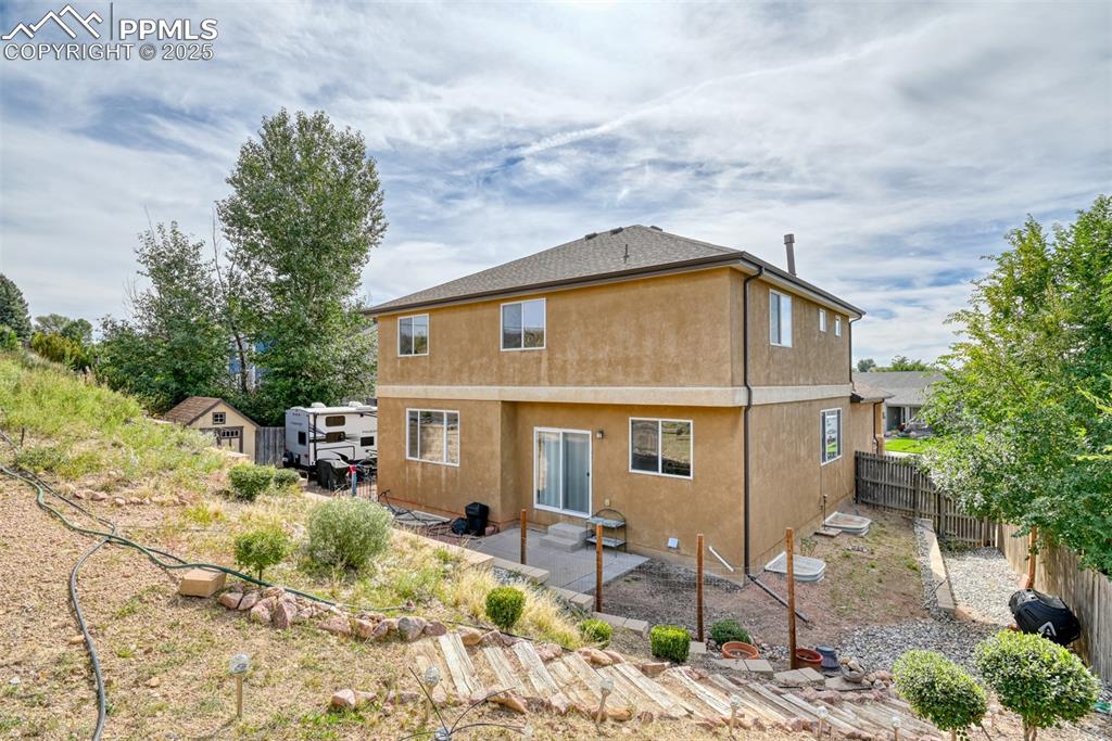 Image 47 of 49: Back of house with a patio area, stucco siding, and a fenced backyard