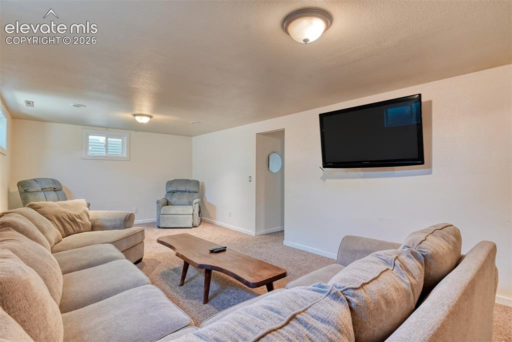 Image 23 of 32: Wall-mounted television fixture, recessed lighting, and a ceiling-mounted l