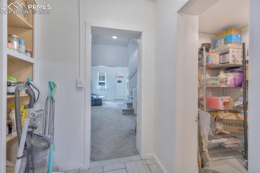 Image 15 of 38: Open shelving and a walk-in pantry provide great space to organize and stor
