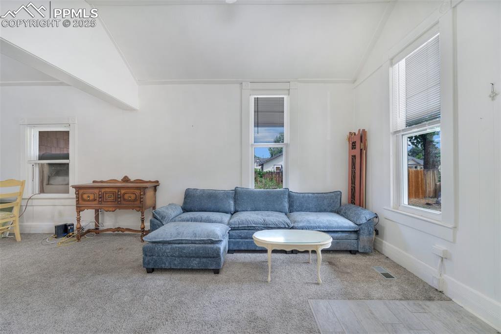 Image 2 of 38: From the entry, a spacious living room that opens to the dining area and ki