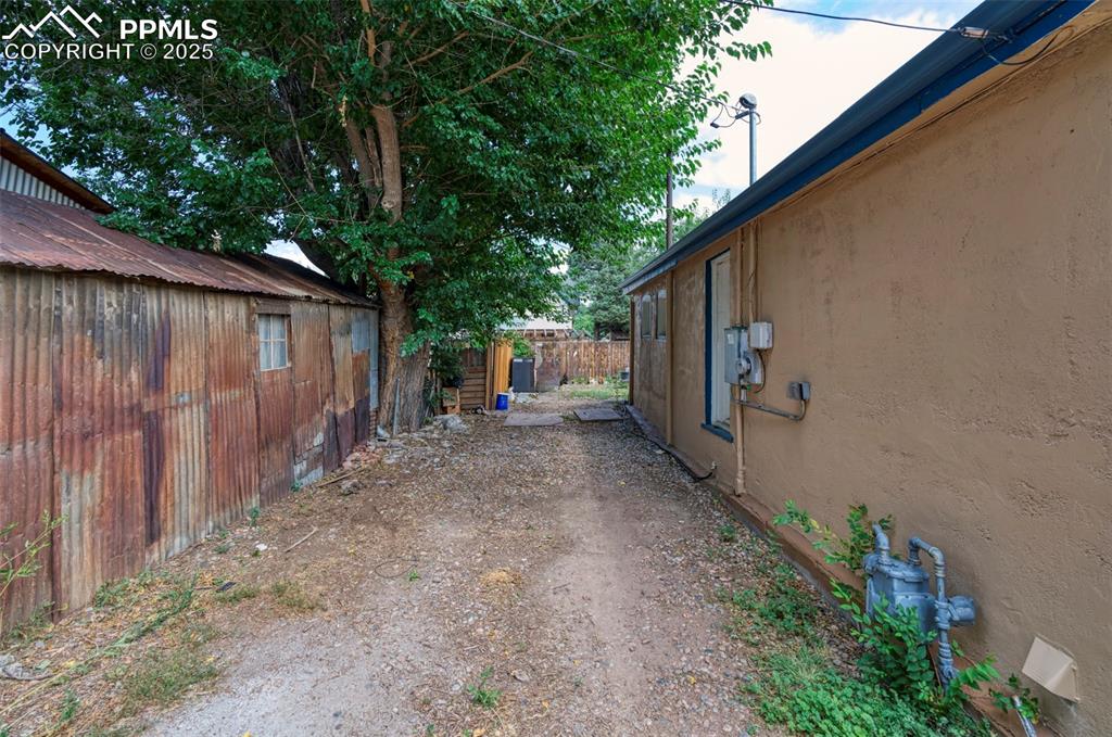 Image 27 of 38: The property is adjacent to the alley.  Not visible behind the home are two