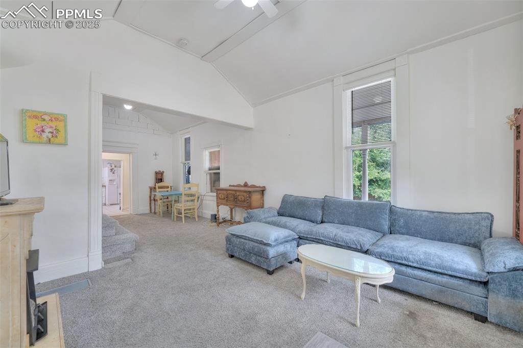 Image 3 of 38: This view shows the staircase to the loft, dining area and kitchen.
