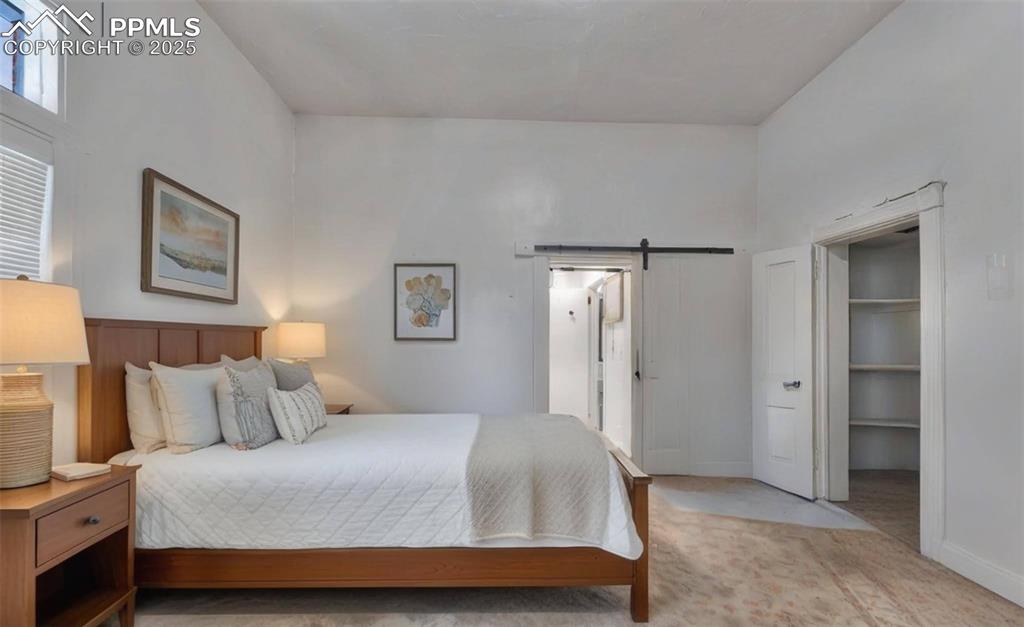 Image 7 of 38: The sitting area in the master bedroom has tile flooring and a  front-facin