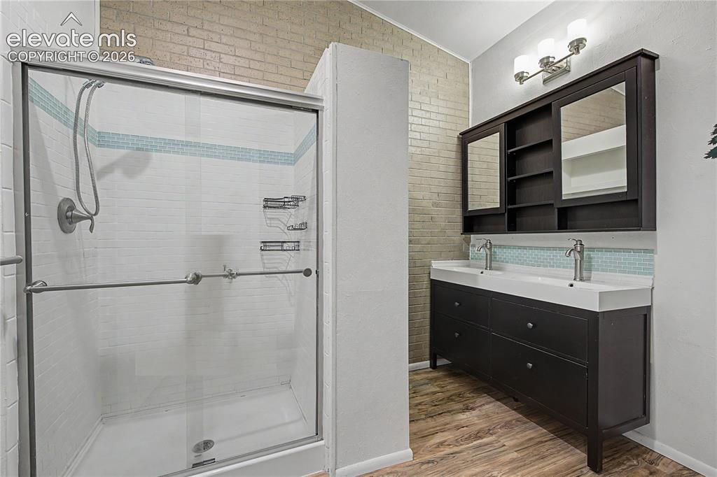 Image 18 of 46: Walk-in shower with clear glass enclosure and tile surround