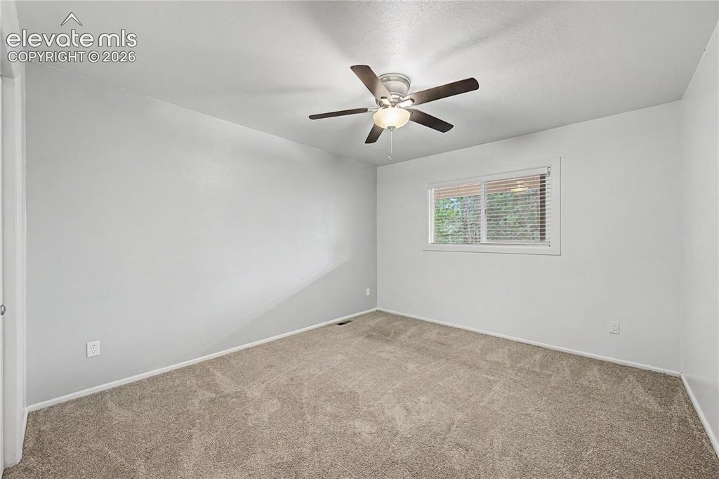 Image 26 of 46: Neutral tone walls with soft gray carpeting