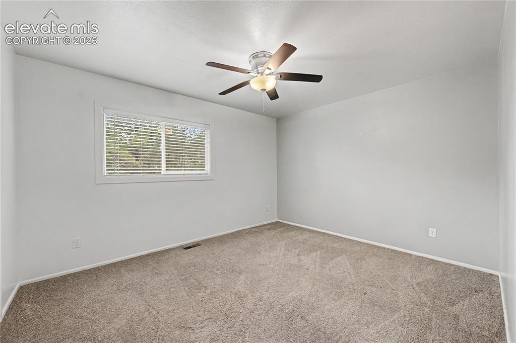 Image 30 of 46: Spacious room featuring neutral carpet flooring, light gray wall paint, a c