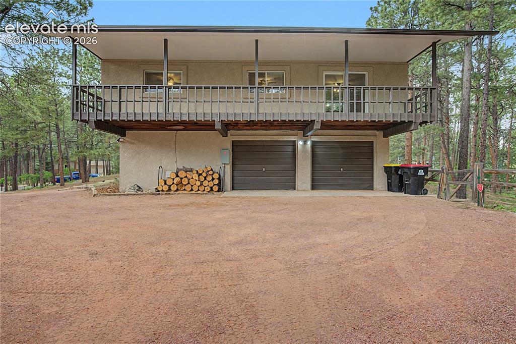 Image 43 of 46: Elevated residence featuring a stucco exterior and an expansive upper-level