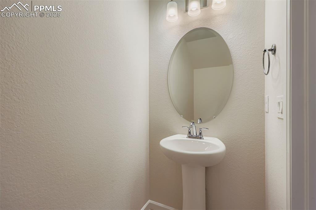 Image 13 of 30: Half bathroom with a textured wall