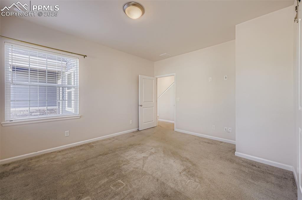 Image 16 of 30: Spare room featuring carpet flooring and baseboards