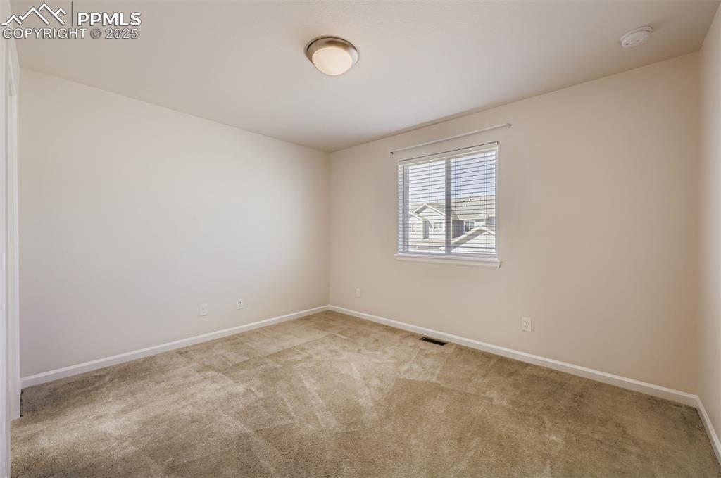 Image 19 of 30: Empty room featuring carpet floors and baseboards