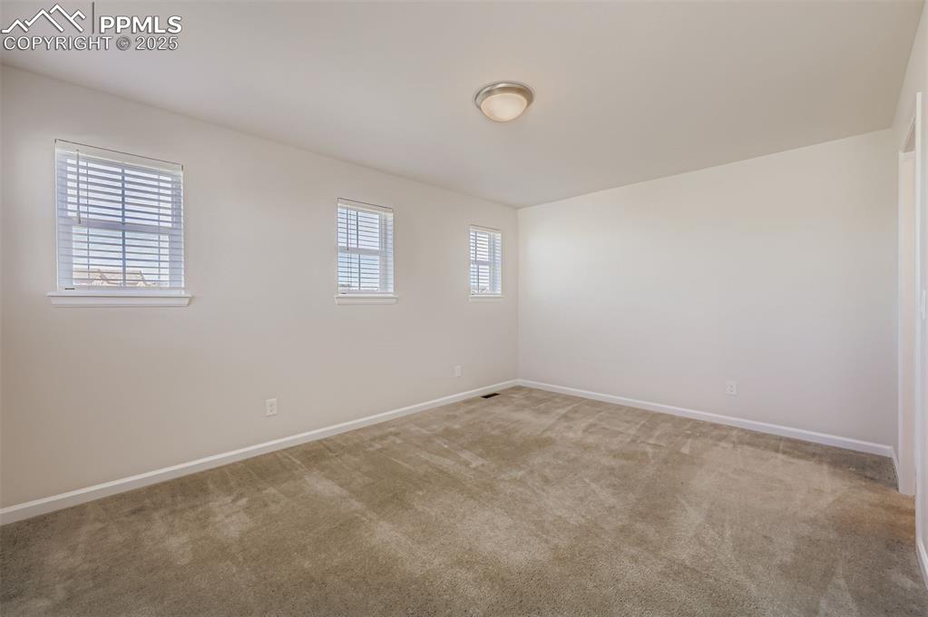 Image 21 of 30: Spare room with healthy amount of natural light and carpet