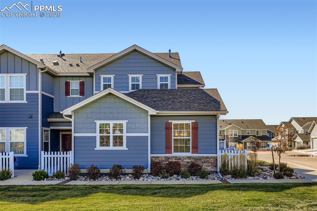 Image 3 of 30: View of front of home featuring roof with shingles, stone siding, board and