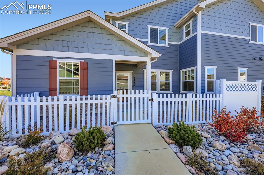 Image 4 of 30: View of front of house featuring a fenced front yard and a gate