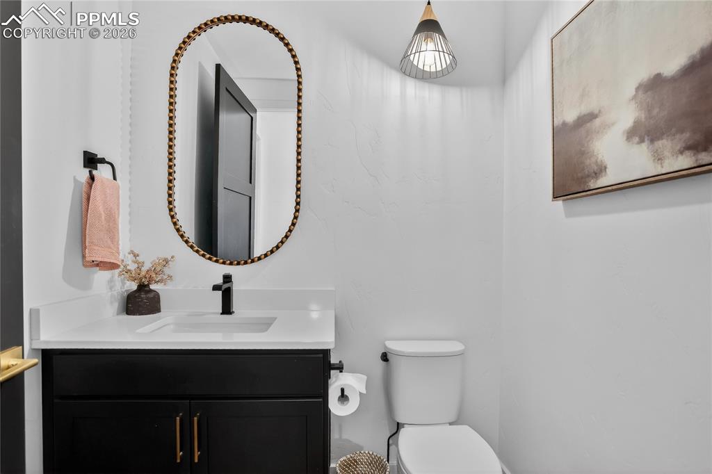 Image 17 of 49: Main floor Powder Room off Foyer