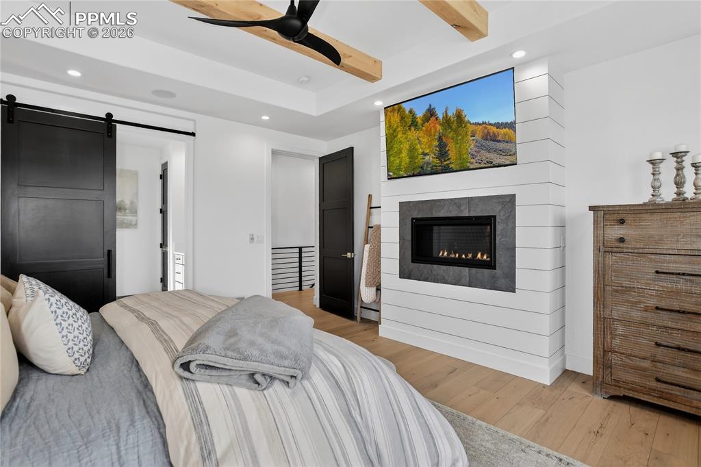 Image 19 of 49: Main floor Primary BR with gas fireplace