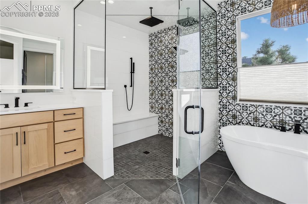 Image 21 of 49: Main floor Primary Bath with walk-in shower, fresetanding tub and radiant h