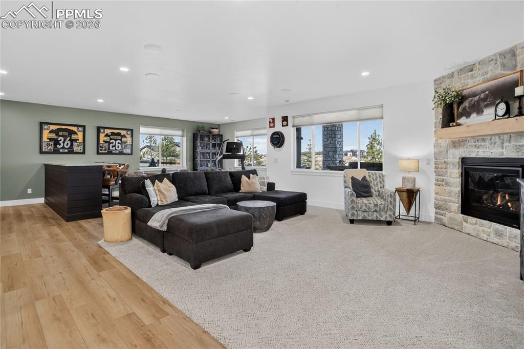 Image 26 of 49: Basement Recreation Room with stone fireplace
