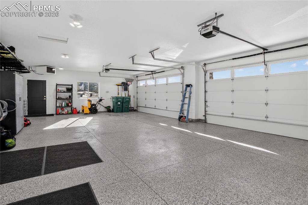 Image 37 of 49: Heated 4-car attached garage with epoxy floors, hot & cold water and power 