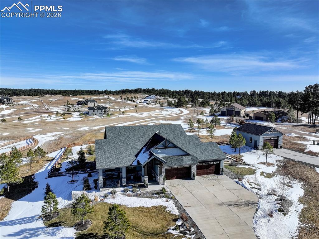 Image 49 of 49: West facing front elevation showing detached 4-car garage / workshop