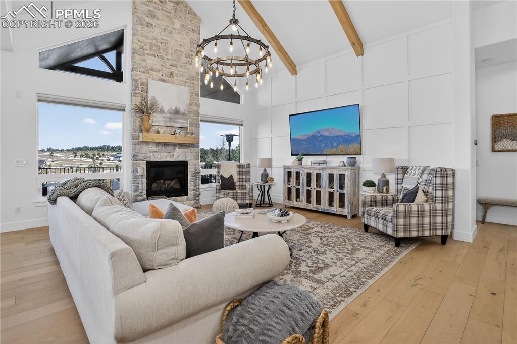 Image 6 of 49: Great Room with vaulted ceilings, knotty alder wood beams, stone fireplace,