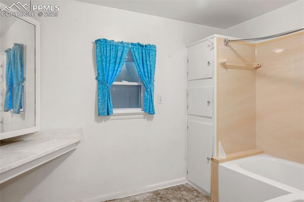 Image 12 of 24: Bathroom featuring baseboards