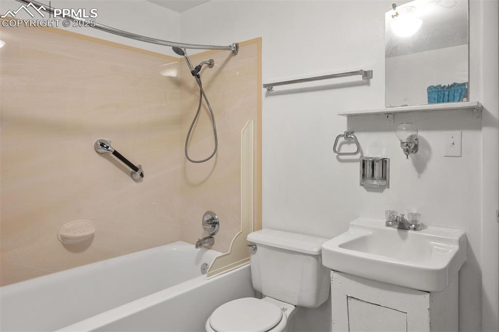 Image 13 of 24: Bathroom featuring shower / bathtub combination and vanity