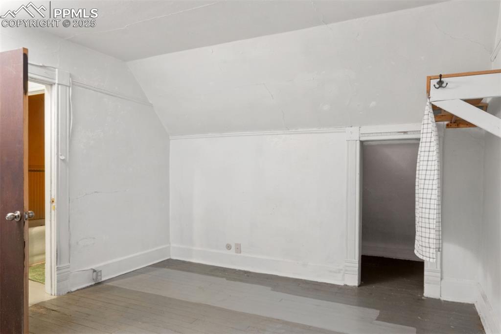 Image 15 of 24: Bonus room with hardwood / wood-style flooring and vaulted ceiling