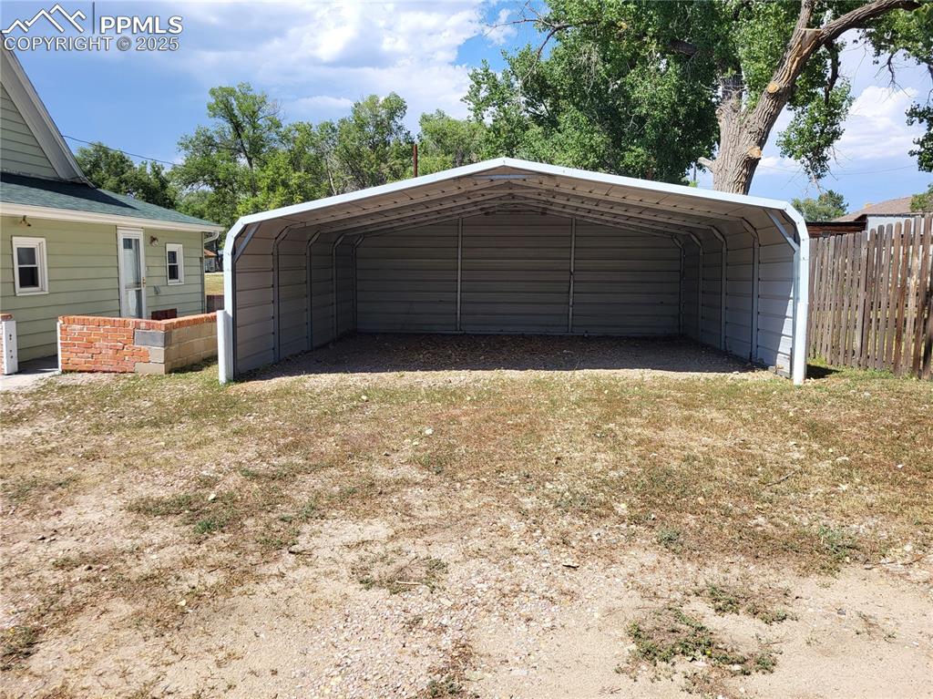 Image 20 of 24: Garage featuring a detached carport