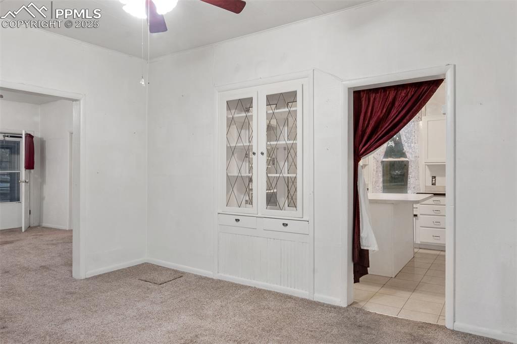 Image 5 of 24: Unfurnished room with light carpet and a ceiling fan