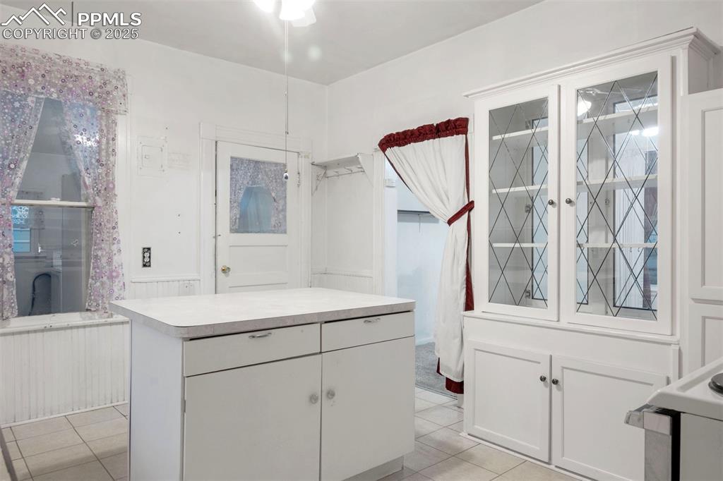 Image 7 of 24: Full bathroom with light tile patterned floors and vanity