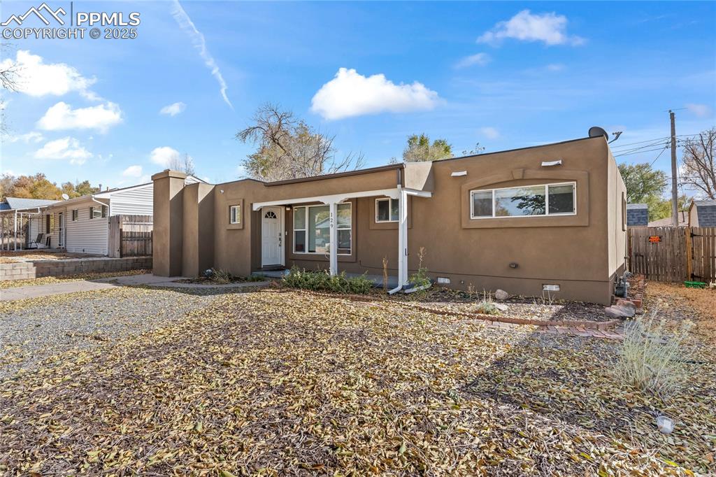 Image 23 of 24: View of front facade featuring crawl space and stucco siding