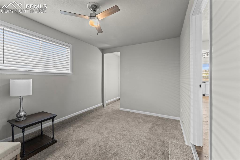 Image 6 of 24: Unfurnished bedroom with light carpet and ceiling fan