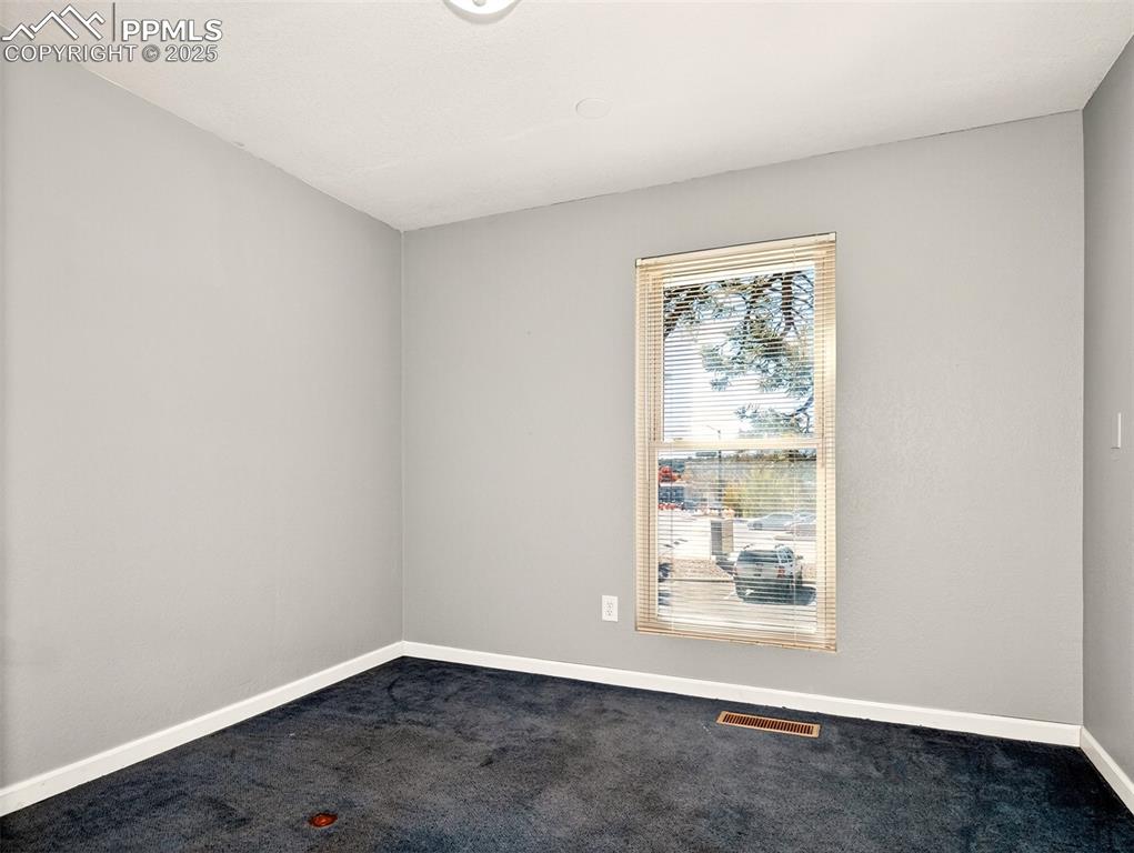 Image 12 of 17: Unfurnished room featuring baseboards and carpet floors