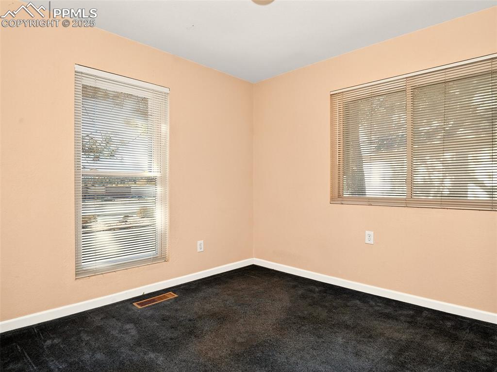 Image 14 of 17: Empty room with carpet floors and plenty of natural light