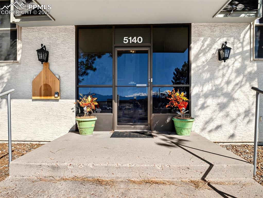 Image 4 of 17: Entrance to property featuring stucco siding