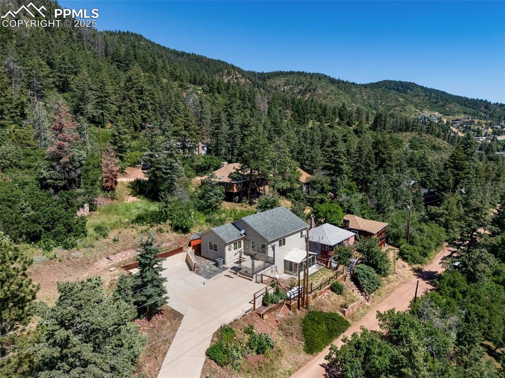 Caption: Aerial view of property and surrounding area featuring a forest