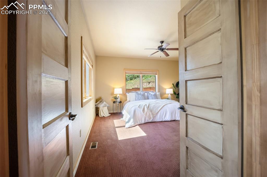Image 14 of 50: Carpeted bedroom featuring baseboards and ceiling fan