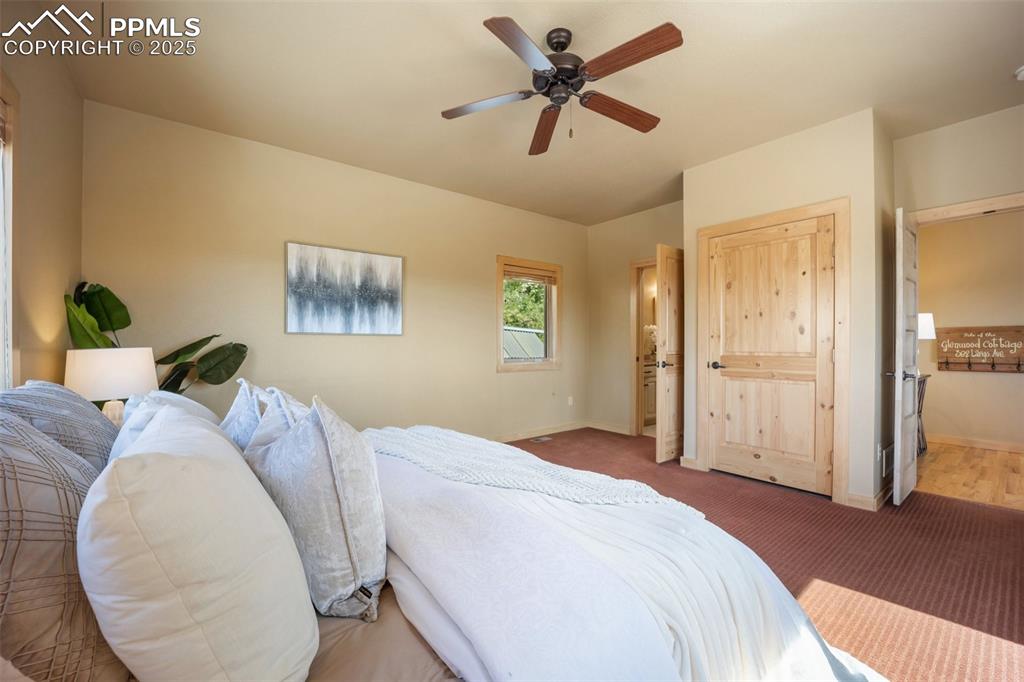Image 16 of 50: Carpeted bedroom with baseboards and a ceiling fan