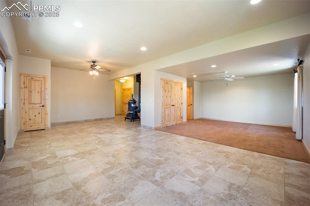 Image 27 of 50: Spare room featuring ceiling fan, recessed lighting, a barn door, light car