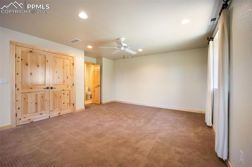 Image 28 of 50: Unfurnished bedroom with recessed lighting, carpet flooring, ensuite bathro