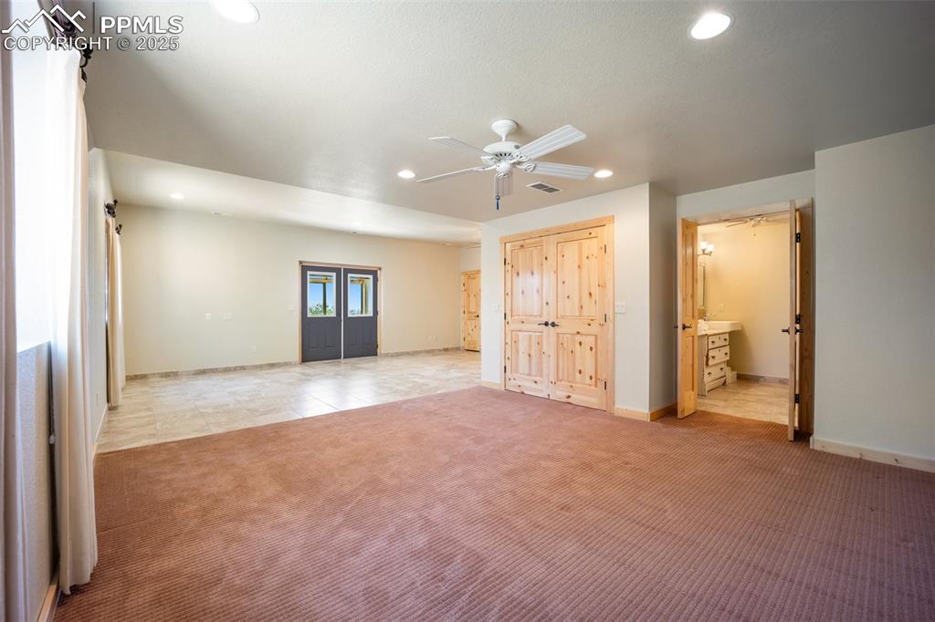 Image 29 of 50: Unfurnished bedroom featuring light carpet, recessed lighting, and ensuite