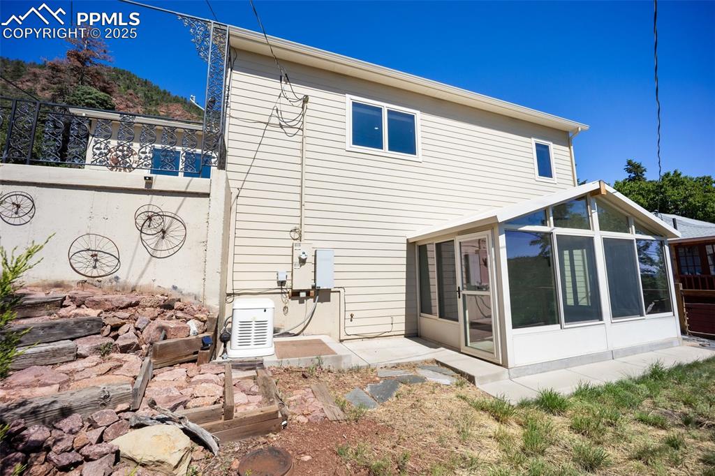 Image 35 of 50: Back of property with a sunroom