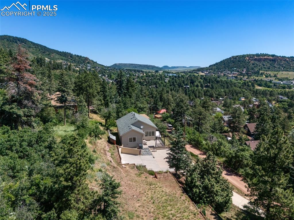 Image 40 of 50: View of subject property with a forest and mountains