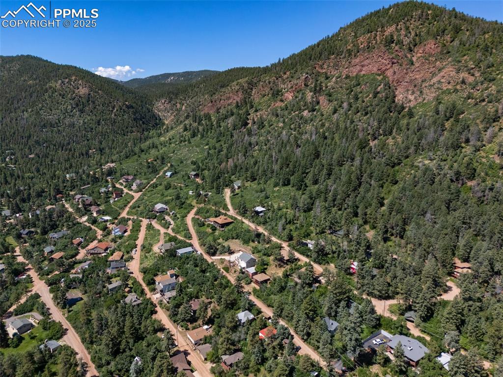 Image 43 of 50: View of mountain background featuring a heavily wooded area