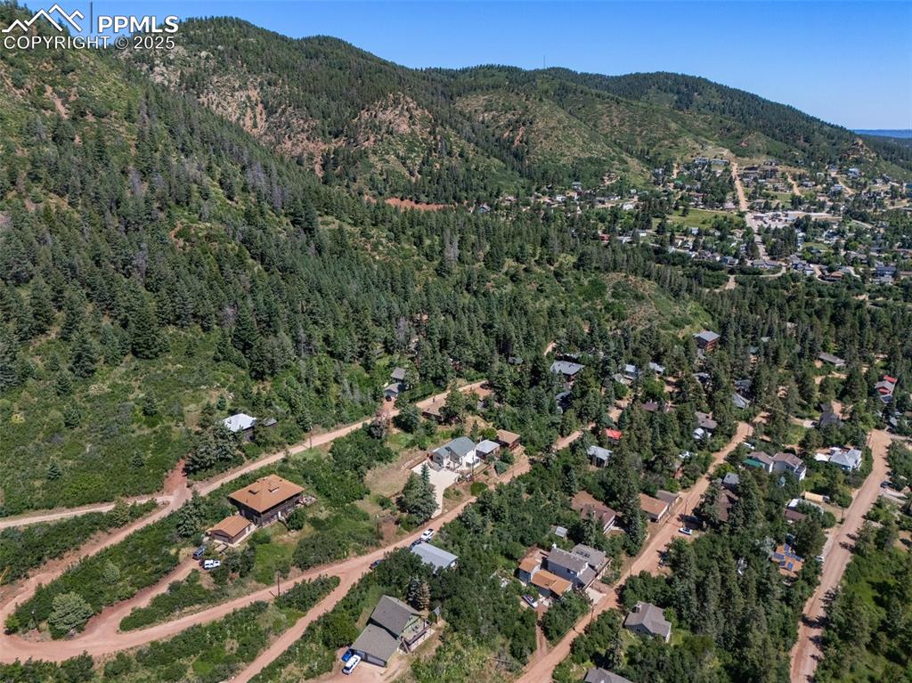 Image 44 of 50: Aerial view of property and surrounding area featuring a mountain backdrop