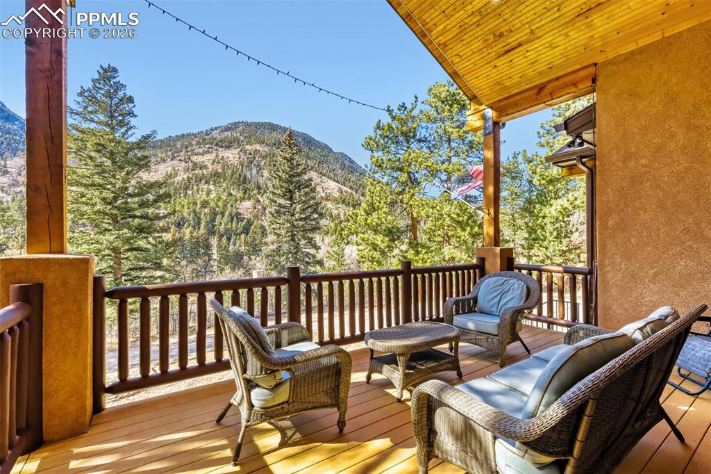 Image 10 of 47: Wooden deck featuring outdoor lounge area and a mountain view
