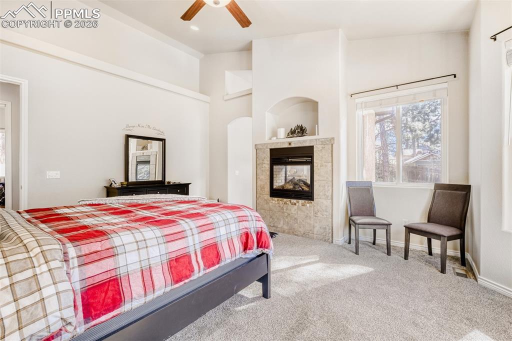 Image 19 of 47: Main Level primary ensuite bedroom with fireplace and awesome mountain view