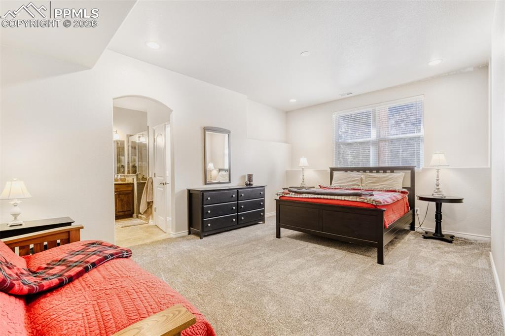 Image 29 of 47: Junior basement guest suite bedroom with new carpet floors, ceiling fan, an